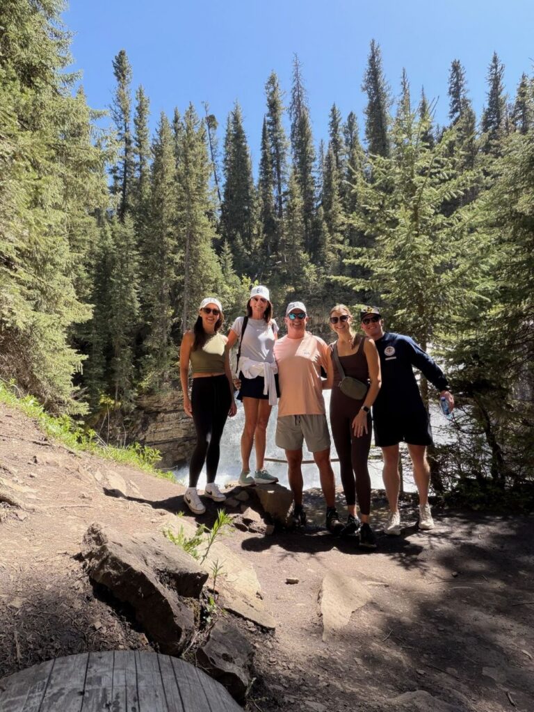 Erben Associates team members on a hike in a forrest